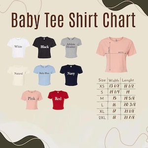 May include: A Baby Tee Shirt Chart displaying eight short-sleeve crop tops in white, black, athletic heather, natural, baby blue, navy, pink, and red. A pink shirt shows length and width measurement lines with a table listing sizes XS to 2XL in inches.