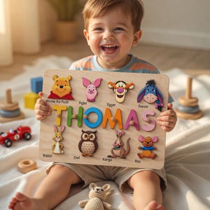 May include: Wooden puzzle board featuring Winnie the Pooh characters and the name "THOMAS" in colorful letters. The puzzle includes characters like Piglet, Tigger, Eeyore, Rabbit, Owl, Kanga, and Roo. A fun and educational toy for children.