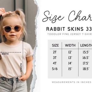 May include: A child in a light-colored t-shirt and sunglasses. The image features a size chart for Rabbit Skins 3321 toddler fine jersey t-shirts, with measurements in inches. The chart shows sizes 2T to 5/6, with widths from 30.5cm to 38.1cm and lengths from 39.4cm to 47cm.