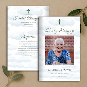 May include: A funeral program template featuring a light blue cloud background, a green cross icon, and the text In Loving Memory of Mildred Brown, February 14, 1938 – May 10, 2025, with a photo of an elderly person and a reflection poem.