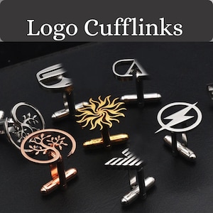 Può includere: Una collezione di gemelli con vari loghi, tra cui un sole, un fulmine e lettere. I gemelli sono realizzati in metallo argentato e dorato. Il testo "Logo Cufflinks" è presente nella parte superiore.