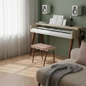 May include: A modern piano with a light wood finish, set against a green wall. The piano has a white keyboard and is accompanied by a matching stool with a pink seat. Speakers and a microphone are mounted nearby.