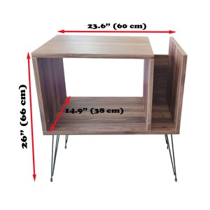 May include: A wooden side table with a walnut finish, measuring 26 inches (66 cm) high, 23.6 inches (60 cm) wide, and 14.9 inches (38 cm) deep. The table has a unique open design with hairpin legs, suitable for living rooms or bedrooms.