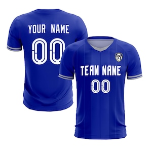 May include: Two blue soccer jerseys. One jersey displays "YOUR NAME" and the number "00" in white. The other jersey shows "TEAM NAME" and the number "00" in white. Both jerseys have a V-neck and a team logo.