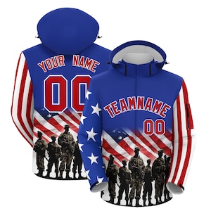 May include: A blue hooded jacket with a patriotic design featuring the American flag, stars, and silhouettes of soldiers. The jacket has red and white stripes on the sleeves and the text "YOUR NAME" and "TEAMNAME" with the number "00".