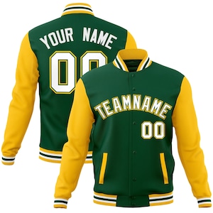 May include: Green and gold varsity jacket with the text "TEAMNAME" and "00" on the front. The back of the jacket has the text "YOUR NAME" and "00". The jacket has a button-up front, striped cuffs, and a striped collar.