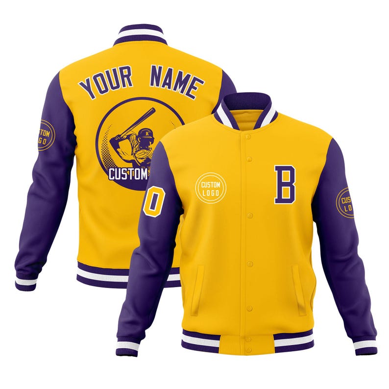 May include: Yellow and purple baseball jacket with white trim. The jacket features the text "YOUR NAME" on the back, a baseball player graphic, and the letter "B" on the front. The sleeves are purple with a white and purple striped cuff.