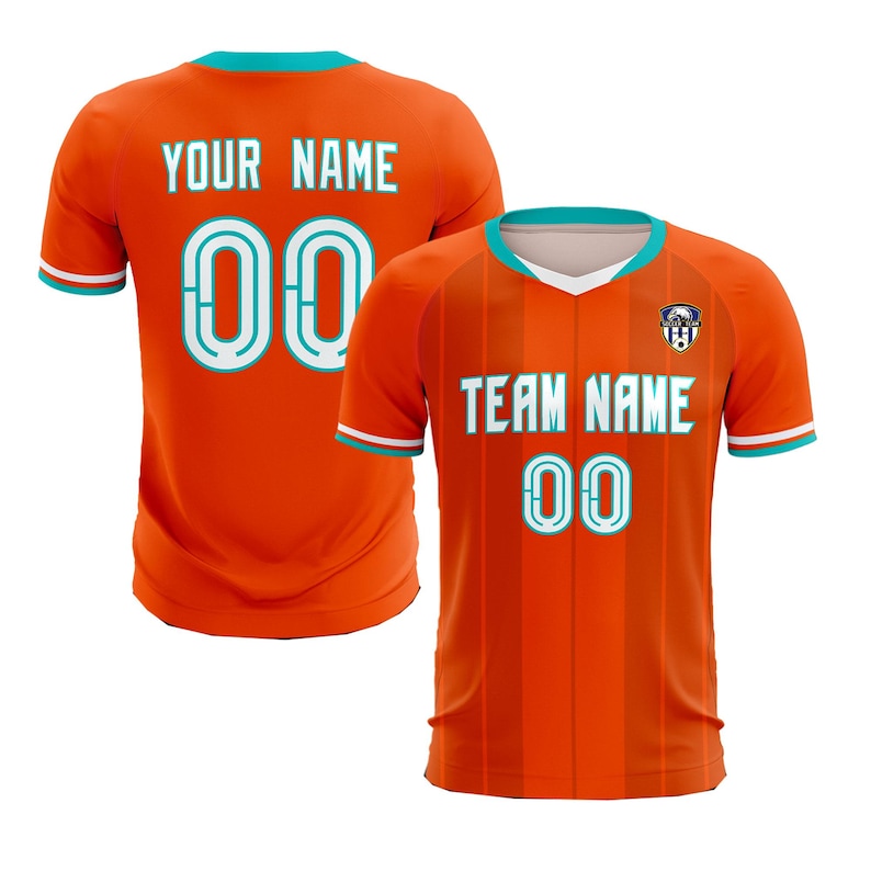 May include: Two orange soccer jerseys with teal accents. One jersey displays "YOUR NAME" and the number "00" on the back. The other jersey shows "TEAM NAME" and "00" on the front. Both jerseys have a teal collar and sleeve trim.