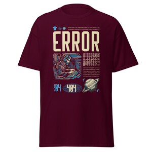 May include: Burgundy t-shirt with a graphic design featuring the word "ERROR" in large white letters. The design includes a programmer, computer screens, a planet, and the numbers "404".