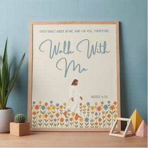 May include: A framed art print with the words "Walk With Me" in a script font. The image shows a figure in white robes walking through a field of colourful flowers. The text "Moses 6:34" is also included.