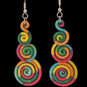 May include: A pair of colorful spiral earrings. Each earring features three graduated, circular spirals in shades of red, orange, yellow, green, and blue. The earrings hang from silver-colored ear wires against a black background.