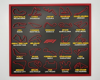 May include: A black and red framed wall art piece featuring 3D renderings of Formula 1 race tracks. Each track is labeled with its location, including Miami, Monaco, and Silverstone. The F1 logo is also visible.