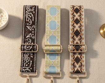 May include: Three adjustable bag straps with gold-tone metal hardware and lobster clasps. The left strap is dark brown with a white paisley pattern. The center strap is light blue and lime green with a geometric grid. The right strap has a diamond pattern.