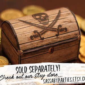 May include: A wooden pirate treasure chest with a skull and crossbones design. The chest is closed and has a metal latch. The chest is surrounded by gold coins.