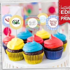 May include: Six colorful cupcakes with different themed toppers. The toppers are round and feature images and text related to the Wizard of Oz. The text on the toppers reads "There's no place like home", "You're off to see the wizard", and "Oz".