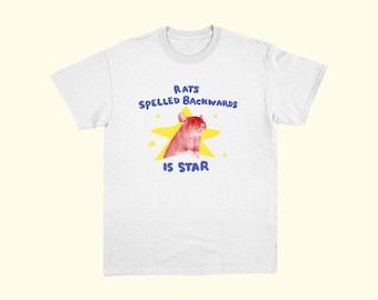 May include: White t-shirt featuring a red and brown rat illustration inside a yellow star. The text above the rat reads "RATS SPELLED BACKWARDS" and below the rat reads "IS STAR".