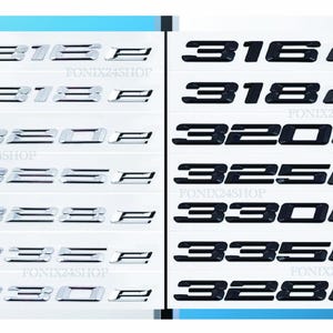May include: A selection of car emblem stickers, displaying model numbers such as "316e", "318e", "320e", "325e", "330e", "335e", and "328e". The stickers are in silver and black, presented on white backgrounds.