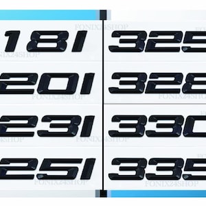 May include: Black car model number emblems on white backgrounds. The emblems include the numbers 318i, 320i, 323i, 325i, 325d, 328d, 330d, and 335d. The text "FONIX24SHOP" is printed on each white background.