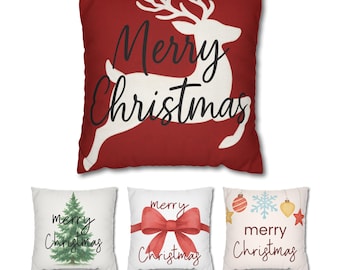 May include: Set of four Christmas-themed throw pillows. One red pillow features a white reindeer and the words "Merry Christmas." The other three pillows are white with Christmas tree, bow, and ornament designs, each with the words "Merry Christmas."
