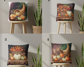 May include: Four decorative throw pillows with autumn-themed designs. Each pillow features a different watercolor illustration of pumpkins, gourds, and cornucopias. The pillows are displayed on small wooden stools, with tall green plants in the background.