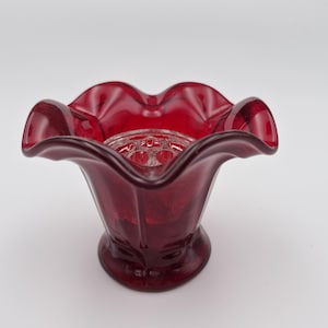 May include: A rustic wooden sign with the text "Welcome to our home" in white lettering. The sign has a distressed finish and a simple, inviting design, suitable for a front porch or entryway.