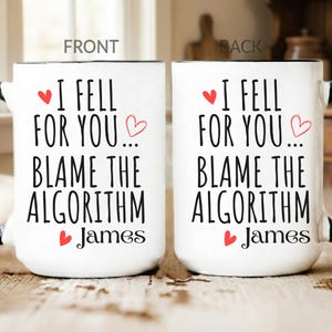 May include: White ceramic mug with a black handle and rim. The mug features the text "I FELL FOR YOU... BLAME THE ALGORITHM James" with red heart accents. A charming gift for a loved one.