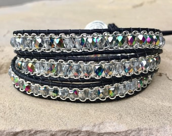 May include: A black leather wrap bracelet with silver chain and iridescent clear glass beads.
