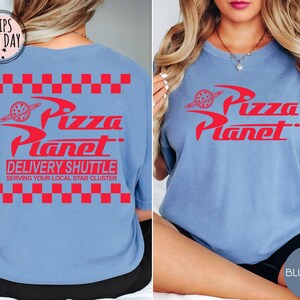 May include: Light blue t-shirts with the red "Pizza Planet" logo and text. The back of the shirt features the logo, "Delivery Shuttle," and "Serving Your Local Star Cluster." The front of the shirt also displays the logo.
