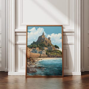 May include: A framed print of a coastal scene featuring a castle atop a hill, with a beach and ocean in the foreground. The artwork has a vintage aesthetic, with a blue sky and white clouds. The frame is made of wood.