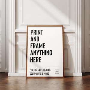 May include: A framed print with the text "PRINT AND FRAME ANYTHING HERE" in bold black letters on a white background. The frame is a warm brown colour. The bottom of the print reads "PHOTOS, CERTIFICATES, DOCUMENTS & MORE".
