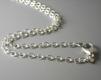 May include: A silver chain necklace with a lobster clasp closure.