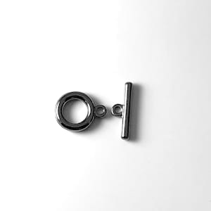 May include: Silver-toned metal toggle clasp with a round ring and a straight bar. The clasp is used for jewelry making.