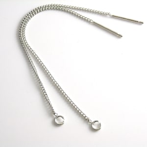 May include: Two silver chains with jump rings at the ends and two silver metal rods.
