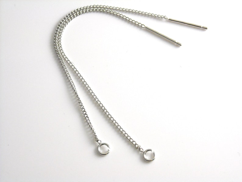 May include: Two silver chains with jump rings at the ends and two silver metal rods.