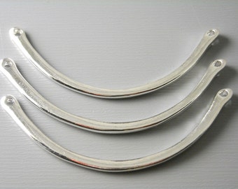 May include: Three silver metal curved connectors with holes at each end.
