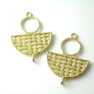 May include: Two gold-tone metal earring findings with a woven design and a circular loop at the top.