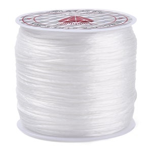 May include: A spool of white elastic cord, labeled "100% Elastic Cord".