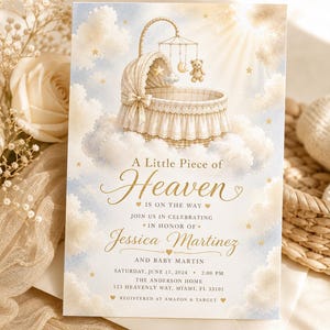 May include: A baby shower invitation with a heavenly theme. It shows a cream-coloured bassinet on a cloud, with a teddy bear mobile. The text reads "A Little Piece of Heaven" and includes event details for Jessica Martinez.