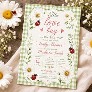 May include: Baby shower invitation with a green gingham background and a floral frame. The invitation features daisies, ladybugs, and the text "A little love bug is on the way." The invitation is for Madison Smith.