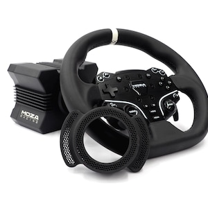 May include: A black Moza Racing steering wheel with a central hub featuring multiple buttons, a white top-center marker, and a separate black circular mesh accessory. The steering wheel is positioned in front of a black Moza Racing motor base unit.