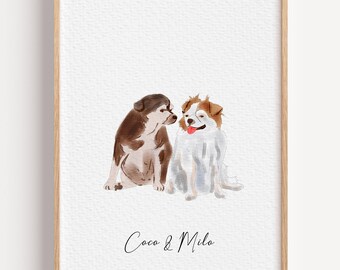 May include: Watercolor print featuring two dogs, one brown and white, the other white and tan, sitting close together. The print is framed in a light wood frame and includes the text "Coco & Milo" in cursive.
