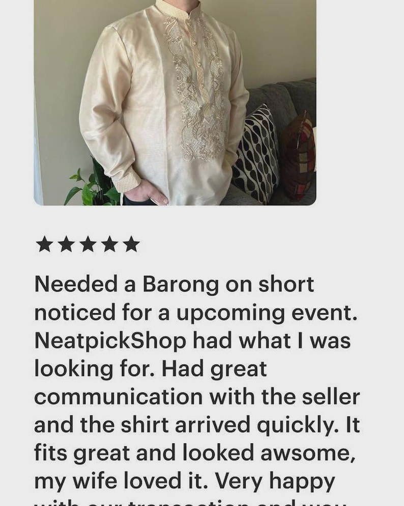 May include: A cream-colored long-sleeved barong shirt featuring a mandarin collar, a button-down front placket, and intricate white floral embroidery detailing along the center panel and cuffs, constructed from a semi-sheer fabric.