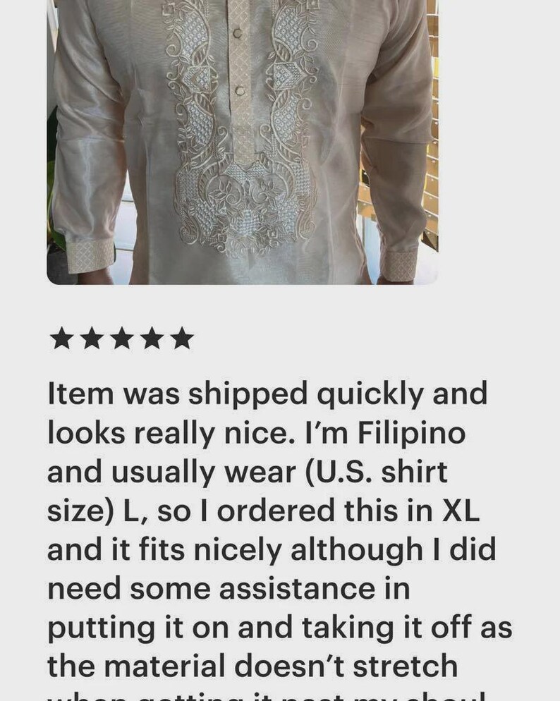 May include: A long-sleeved, cream-colored barong tagalog shirt featuring a button-down placket and intricate white embroidery along the front panel and cuffs. The garment is constructed from a semi-sheer, non-stretch fabric.