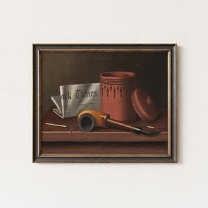 May include: A framed still life painting featuring a tobacco pipe, a red container with a lid, a newspaper with the text "York Times", and two matches. The pipe has a yellow stem and a dark bowl. The container has a decorative pattern.