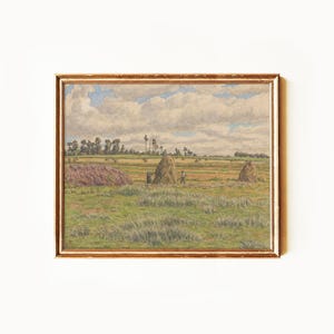 May include: A framed landscape painting shows a field with haystacks and figures under a cloudy sky. The artwork has a gold-coloured frame and a pastoral scene with green and brown tones.