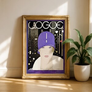 May include: A framed vintage Vogue magazine cover print featuring a stylized illustration of a person wearing a purple cloche hat against a black and white city skyline background. The text VOGUE is printed in large white letters at the top.