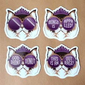 May include: Four die-cut stickers featuring a fluffy cat wearing a purple tiara and round purple sunglasses. The lenses display text: 'MONGO IS APPALLED!', 'GOD DAMNIT DONUT', and 'THIS IS AN OUTRAGE!', while one pair of lenses remains blank.