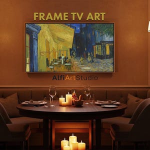 May include: A framed TV art piece displays a painting of a street scene with yellow and blue hues. The artwork hangs above a round table set for dining, with candles and wine glasses. The room has a warm, inviting ambiance.