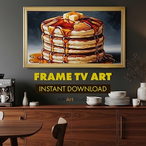 Könnte beinhalten: Gerahmtes Kunstwerk mit einem Stapel Pfannkuchen, übergossen mit Sirup und Butter. Das Kunstwerk trägt die Aufschrift "FRAME TV ART" und "INSTANT DOWNLOAD". Das Bild hängt über einem Holzschrank.