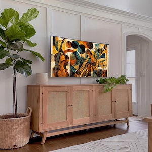 May include: A light wood cabinet with four doors and woven cane panels. A large flat-screen TV displays a colorful jazz-themed artwork. A potted plant and a woven basket are in the foreground, adding a touch of nature to the room.
